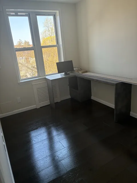 Home office with dark hardwood floors