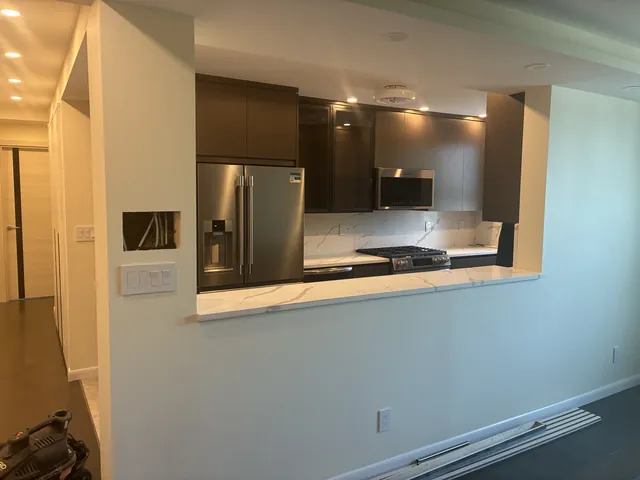 Kitchen pass-through with dark cabinetry