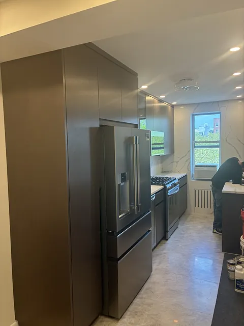 Kitchen with tall dark cabinetry